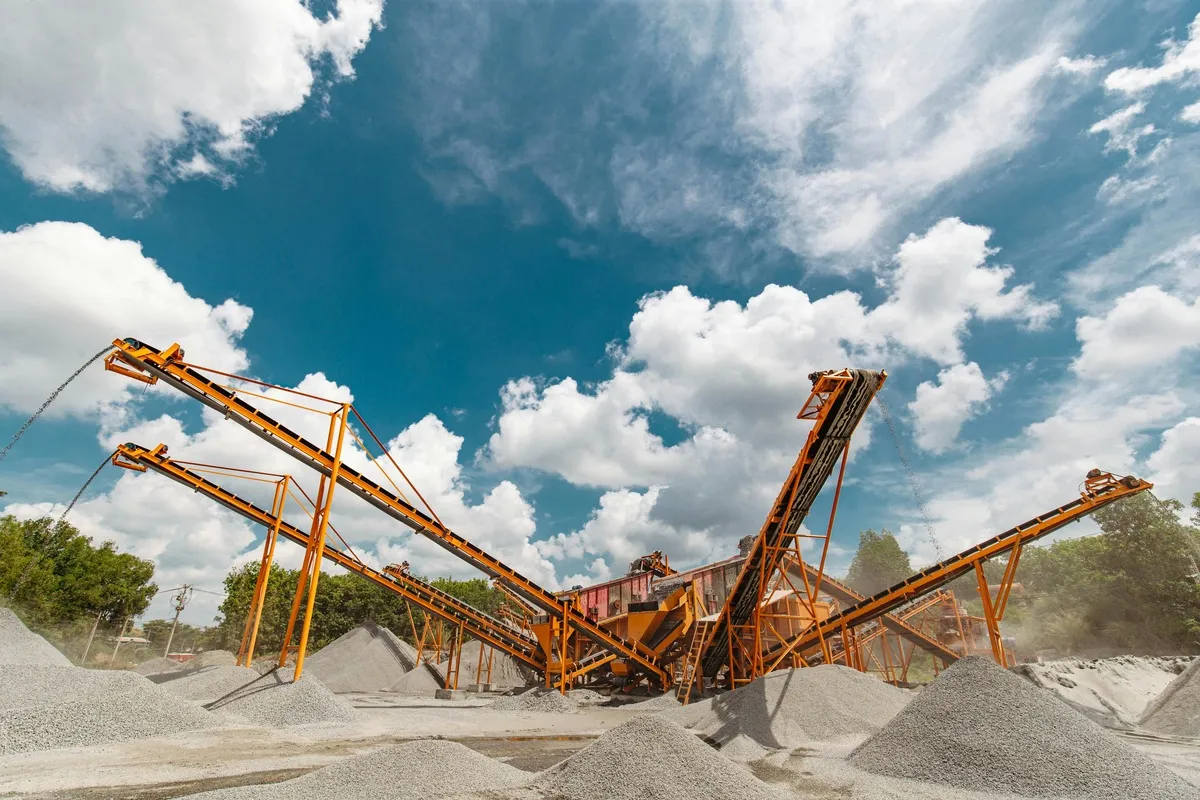 Industrial conveyor system in a gravel quarry showing belt conveyor for material handling
